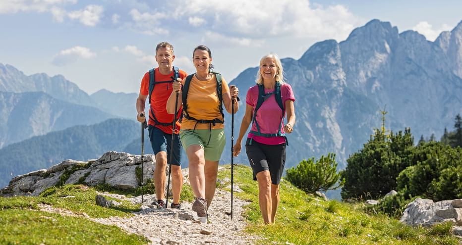 Hiking trio at the Vršič Pass on the Alpe-Adria Trail in Slovenia