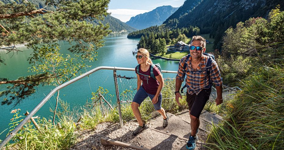 Glückliche Reisende auf Wanderpfad mit Ausblick auf den See