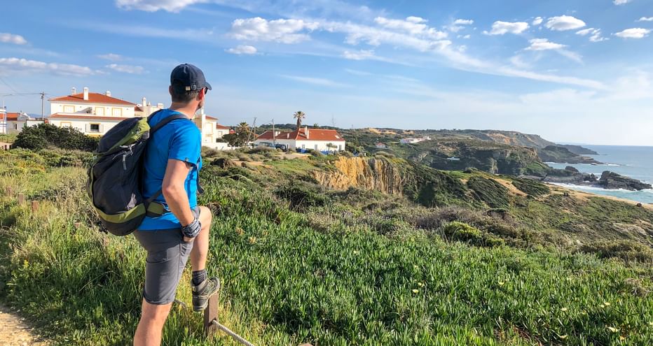 Hiker on a hiking trail with a view of the coast