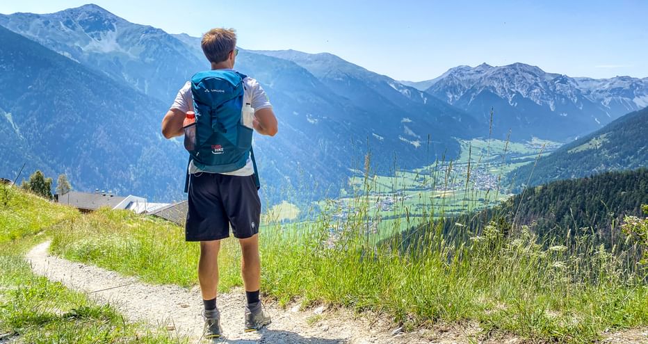 Hiker enjoys the view of the mountain panorama