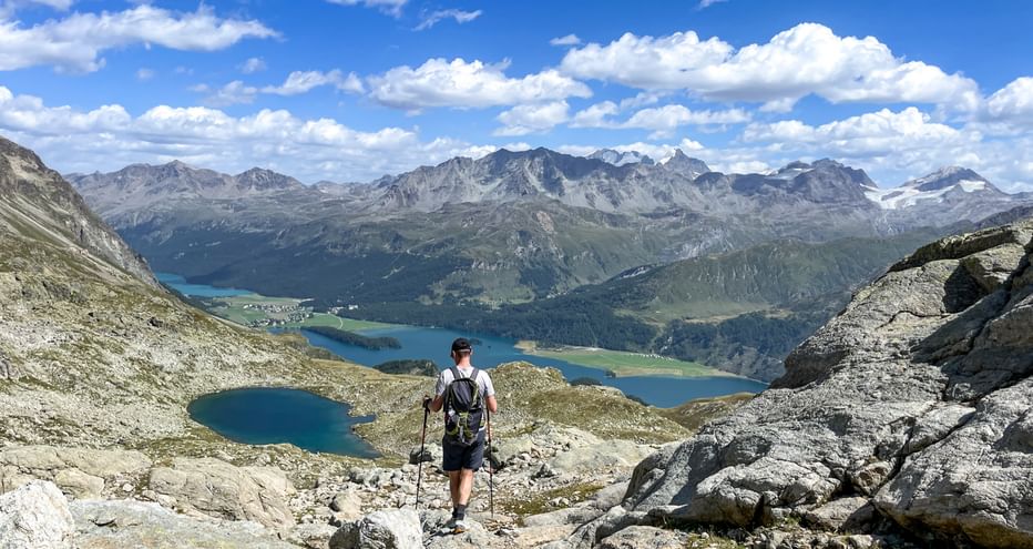 Hikers over Plaun de lej lake
