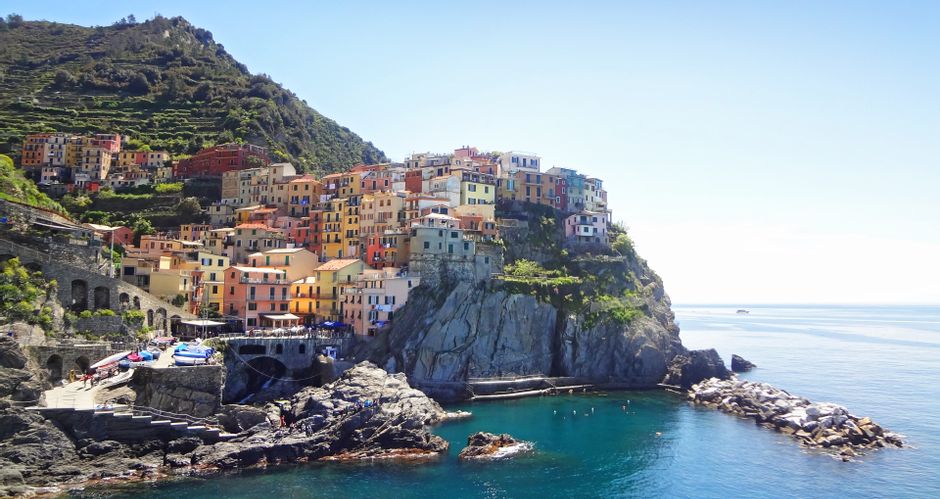 The colourful houses of Manarola in a rocky bay