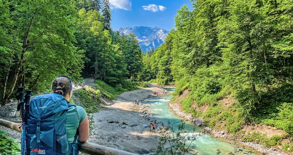 Hiker looks down on stream bed at Partnachklamm gorge