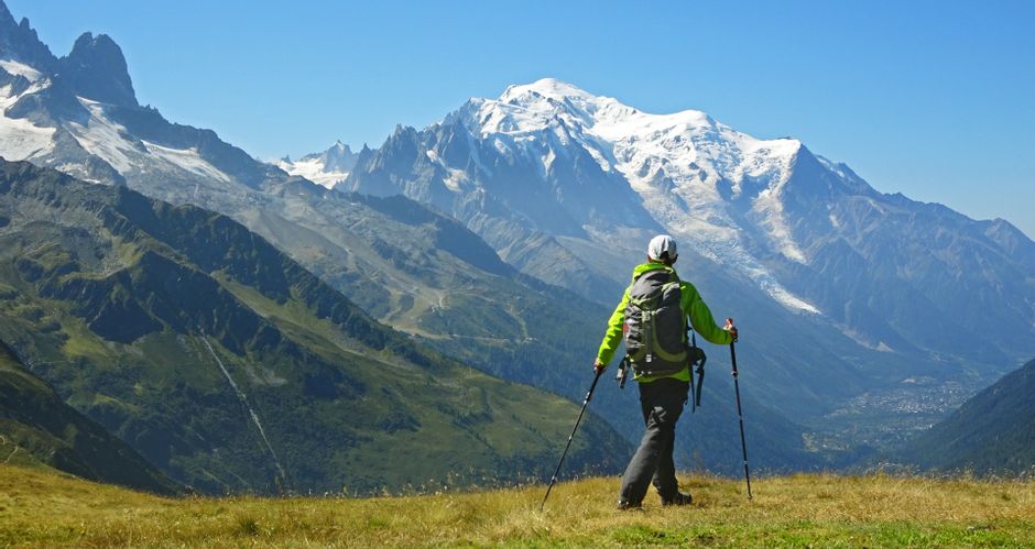 Hikers in front of the imposing mountain backdrop of Mont Blanc