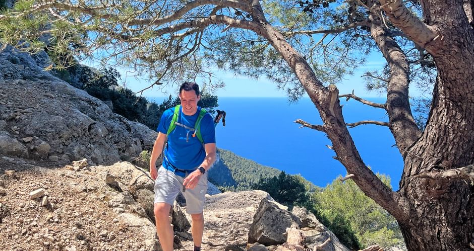Hiker on a mountain in front of the sea