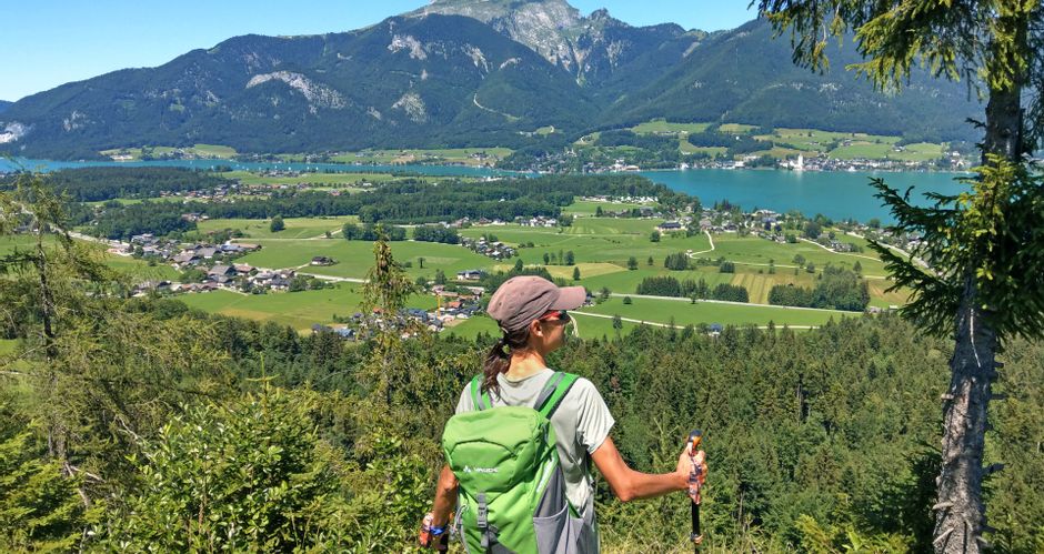 Hiker enjoys the panoramic view of Lake Wolfgang and the Schafberg mountain