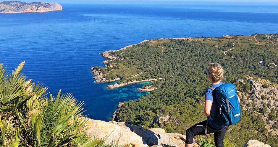 Hiker enjoys the view of the sea and the panorama of the Alcudia peninsula